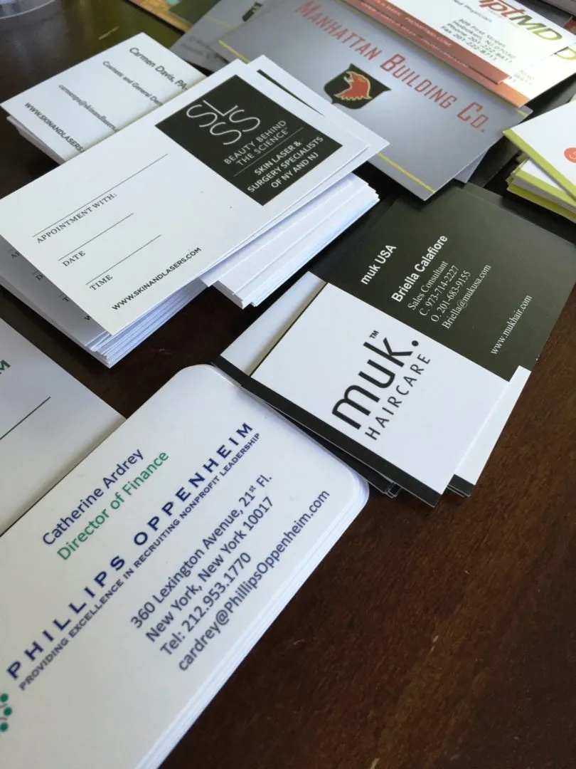 How does a business card help in improving a business?