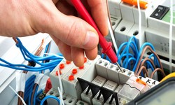 How do electricians ensure compliance with electrical codes and regulations?