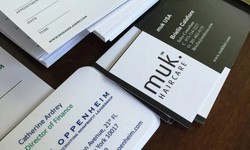 How does a business card help in improving a business?